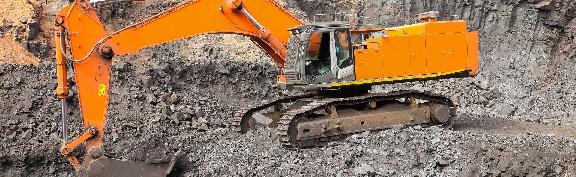 yellow-excavator-digging-ore-rich-rock-open-pit-mine.jpg